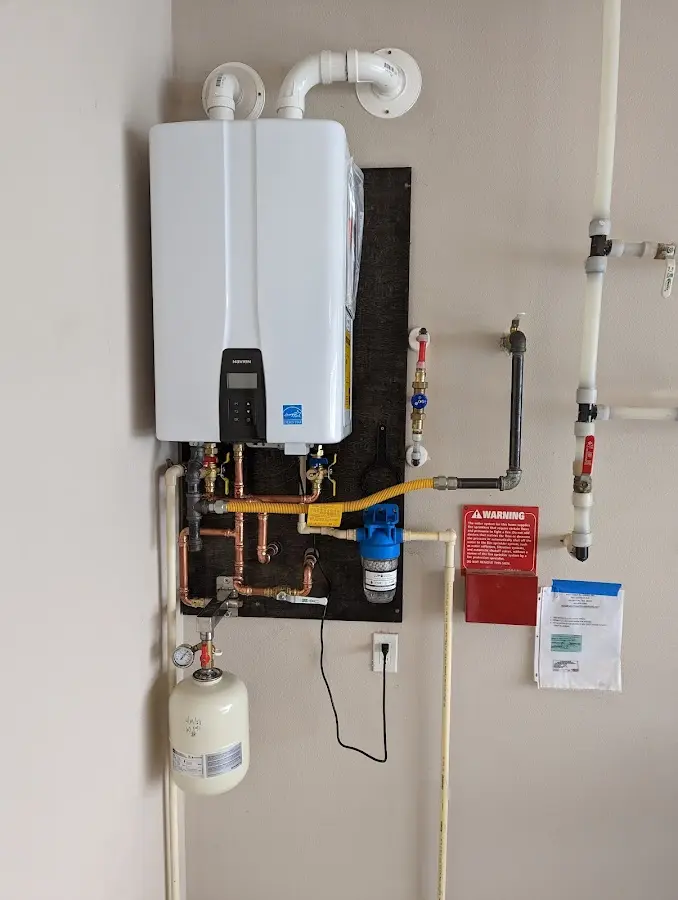 Professional plumber installing copper piping in a Lake Geneva home